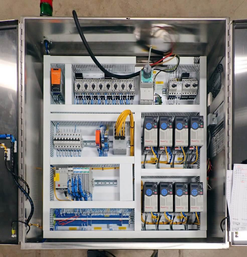 Industrial control panel showing PLC and terminal blocks